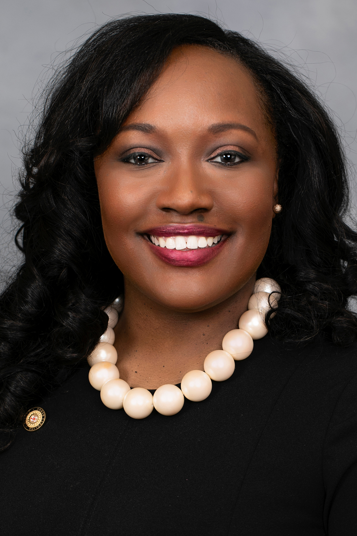 Senator Natalie S Murdock wearing a black blouse with white pearls